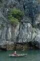 Local fisherman in conical hat and bamboo boat, Halong Bay