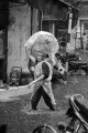 Woman wading through the flooded streets of Hanoi