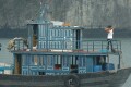 Man doing excercises on typical Halong Bay boat