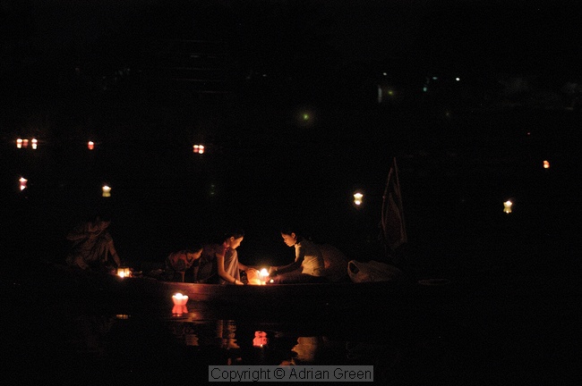 Placing floating candles during the festival of light, Hoi An