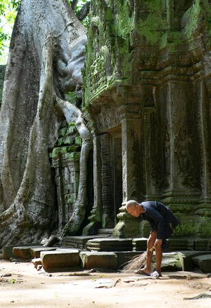 Old man sweeping Ta Prohm, Siem Reap, Cambodia