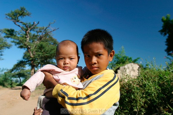 Boy and baby with deep blue sky, Bagan