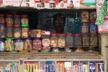 Shopkeeper peers from the darkness of his shop, old Varanasi
