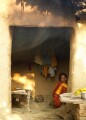 In the countryside near Varanasi: smoke from the open fire trickles out of a mud hut