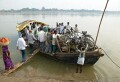 Further up the Ganges from Varanasi a river ferry is loaded up with people, bicycles, motorcycles, goods and animals