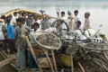 Further up the Ganges from Varanasi a river ferry is loaded up with people, bicycles, motorcycles, goods and animals