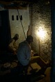 Behind the scenes in old Varanasi the working conditions are not pleasant.   These men work in near darkness grinding small metal components.