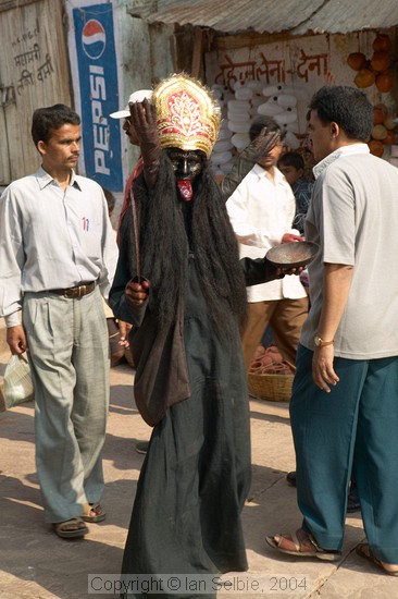 Dressed as Kali and on the way to the Ghats to collect donations, Varanasi